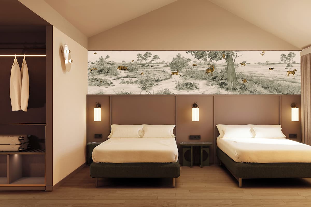 A modern hotel room with two beds, a wardrobe, and a mural of a savannah scene.