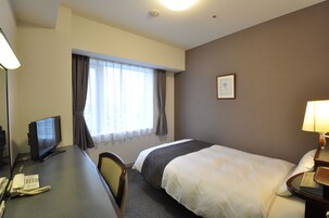 Premium bedding, desk, laptop workspace, blackout drapes