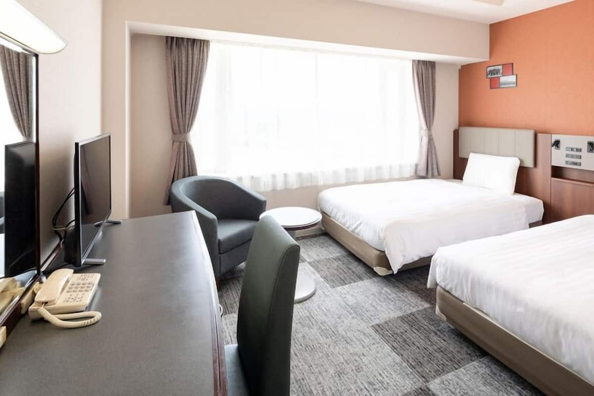Premium bedding, desk, laptop workspace, blackout drapes