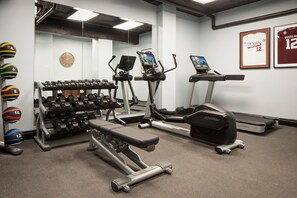 A gym with treadmills, elliptical machines, and a bench press. - The Lasalle Hotel, Bryan College Station, A Tribute Portfolio Hotel (Bryan)