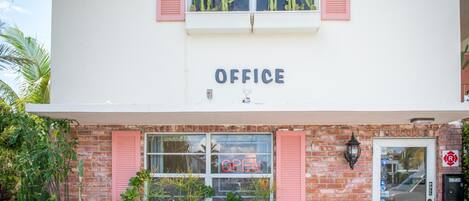 A two-story building with a sign reading "OFFICE" above the entrance.