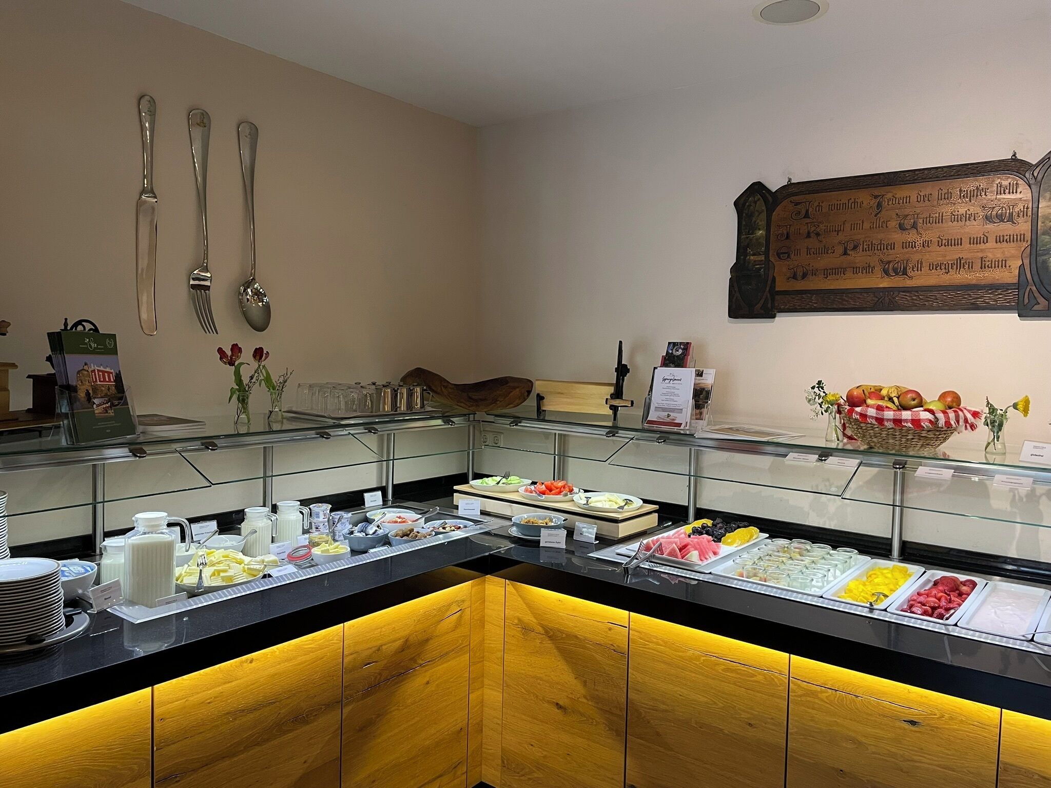A buffet area with various food items and utensils.