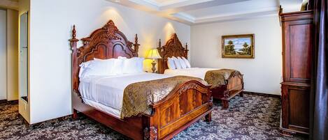 A double bed with a wooden headboard, two bedside tables with lamps, a large mirror, and a painting on the wall.