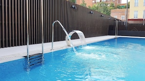 Seasonal outdoor pool, pool umbrellas, pool loungers