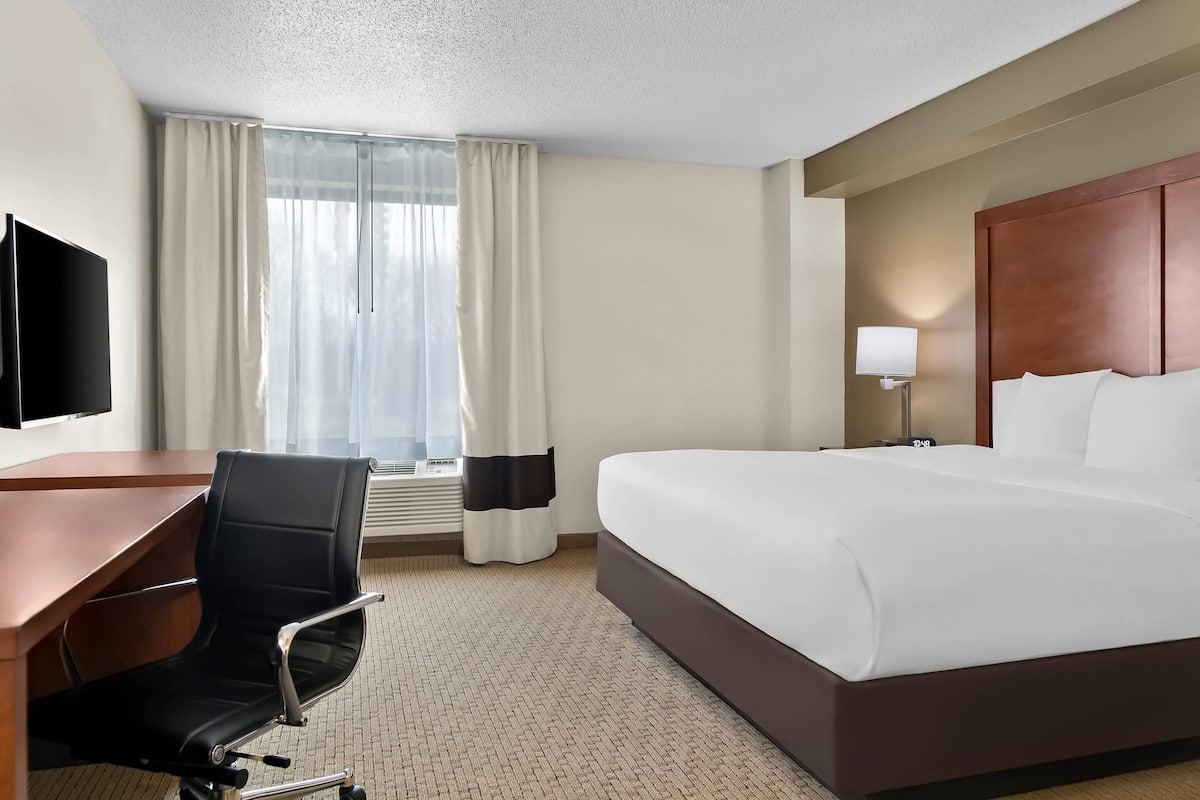 Premium bedding, desk, laptop workspace, blackout drapes