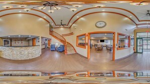 A spacious lobby with a central staircase, a reception desk, and a dining area. - Comfort Inn & Suites Taylor - Detroit (Taylor)