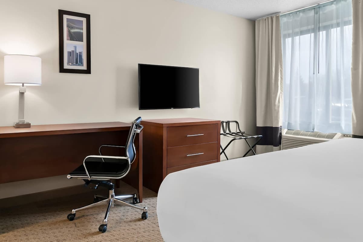 Premium bedding, desk, laptop workspace, blackout drapes