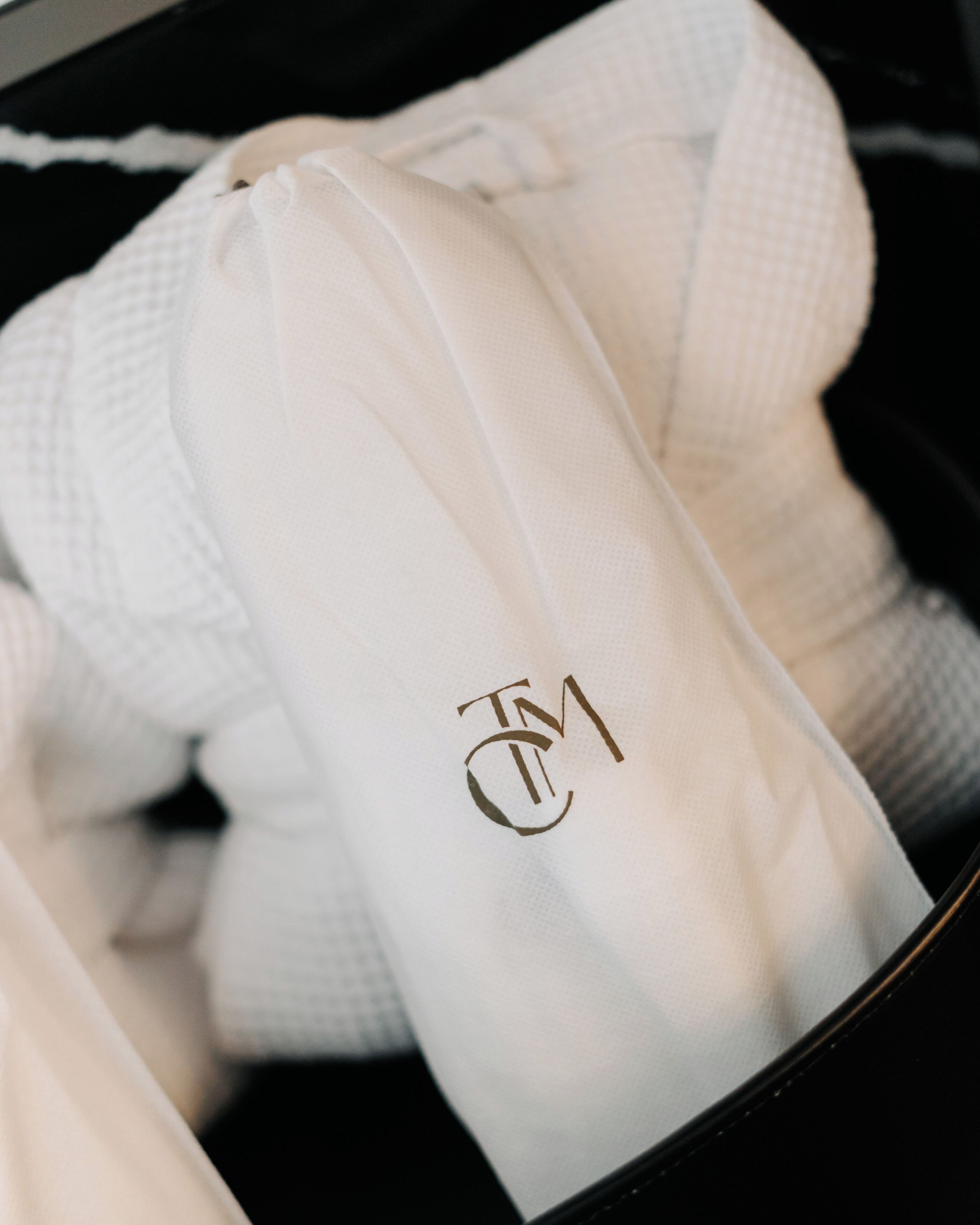A white bag with a logo inside a black box.