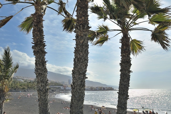 Black sand, sun loungers, beach umbrellas, 2 beach bars