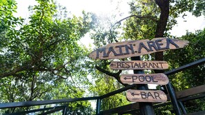 A wooden signpost with directions to 'Main Area,' 'Restaurant,' 'Pool,' and 'Bar.' - Gooderson Bushlands Game Lodge (Hluhluwe)