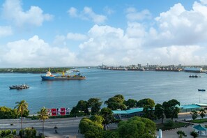 Stroll along the well-maintained promenade with lush greenery and enjoy the views of the bustling harbor.