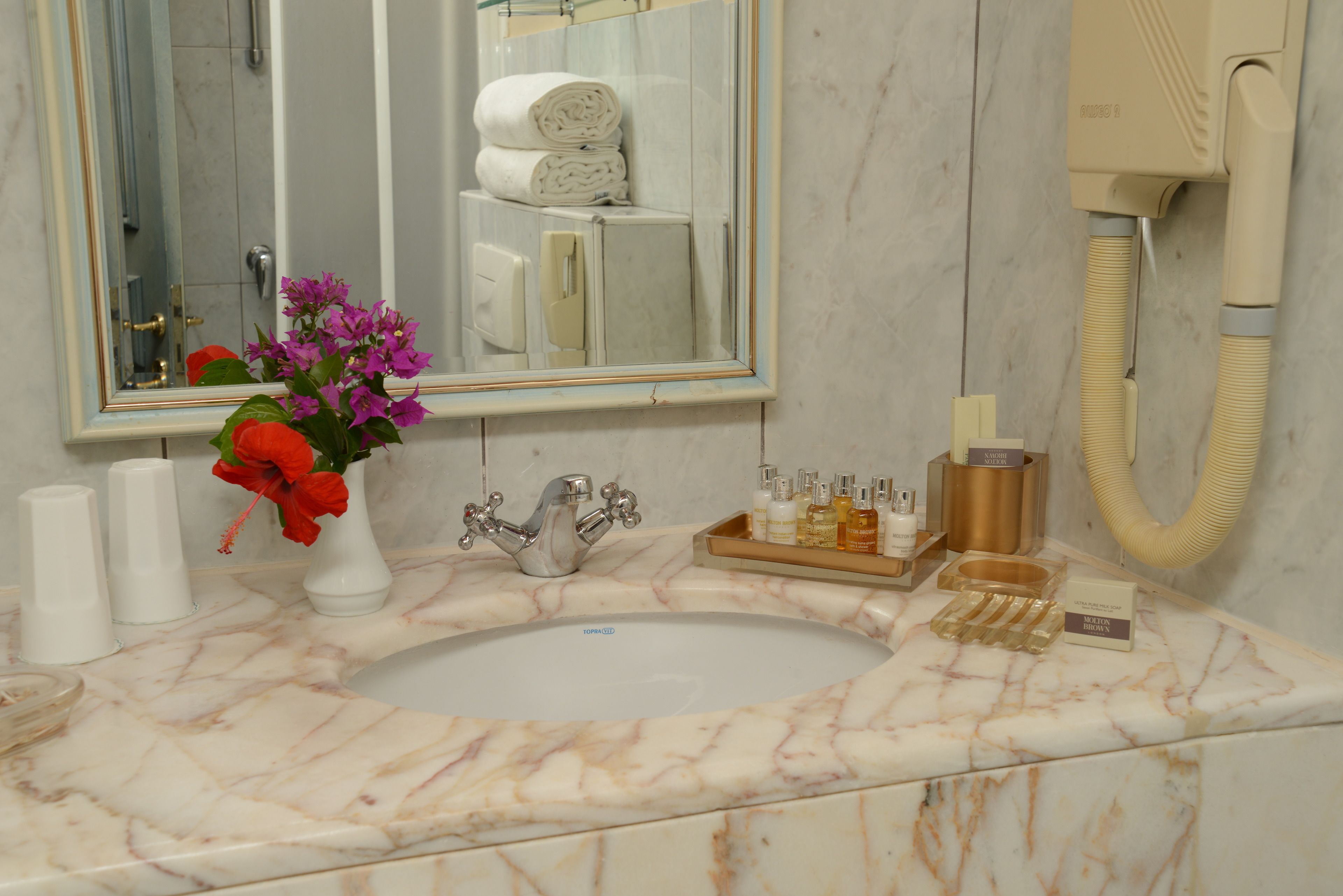 deep-soaking bathtub, rainfall showerhead, hair dryer, slippers