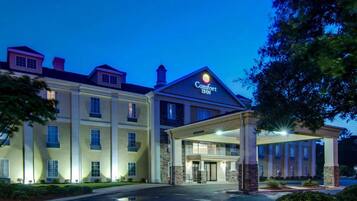 A Comfort Inn hotel with a two-story building, a covered entrance, and a well-lit facade.