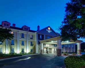 A Comfort Inn hotel with a two-story building, a covered entrance, and a well-lit facade.