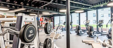 A gym with various exercise equipment, including weight machines and treadmills.