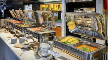 A buffet with various food options, including boiled eggs, pasta, and hash browns.