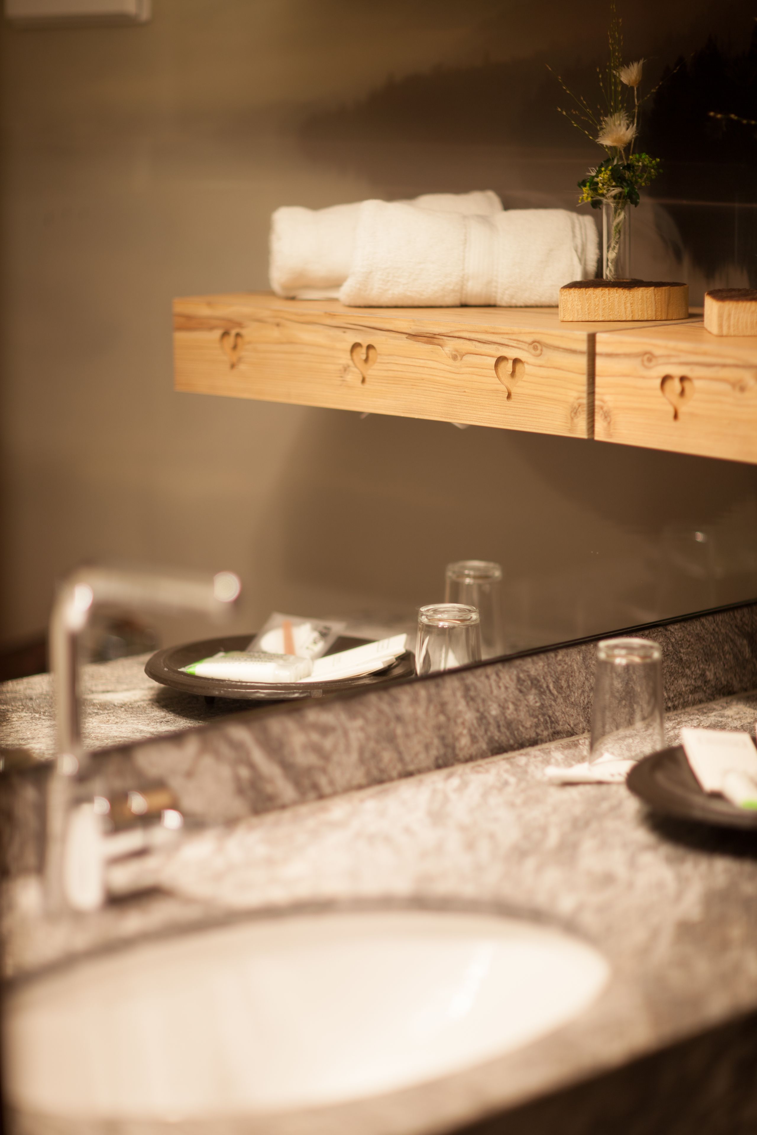 A bathroom vanity with a sink, mirror, and towel rack.