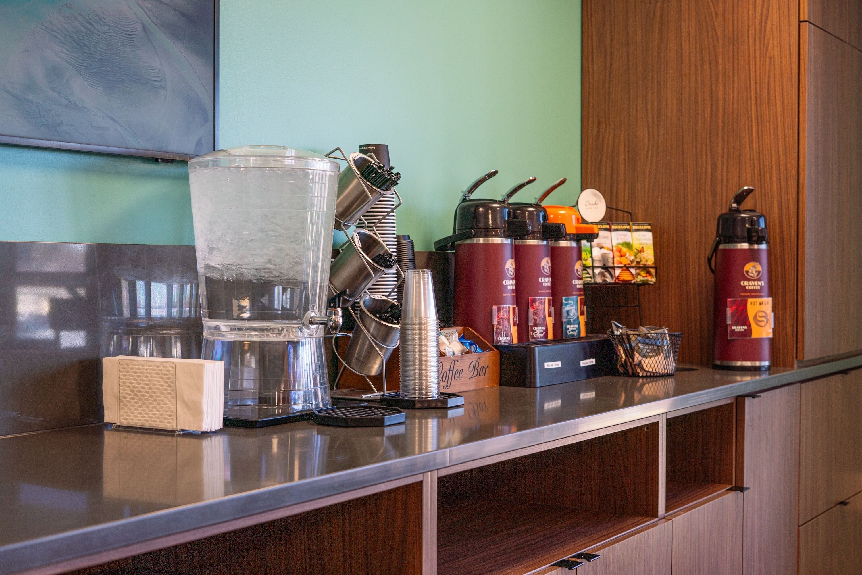 A coffee bar with various coffee-making equipment, including a coffee grinder, espresso machine, and coffee pots.