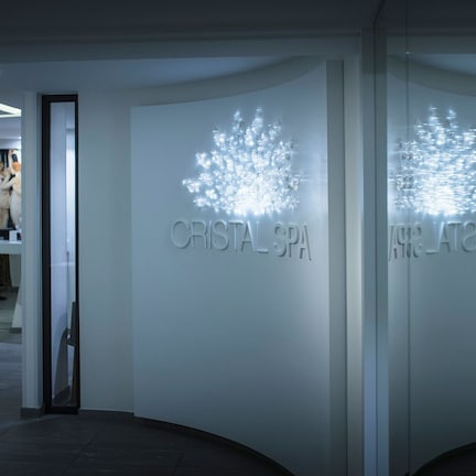 A modern spa with a glass facade and illuminated signage reading "CRISTAL SPA."