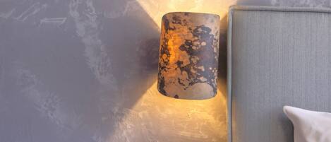 A wall-mounted light fixture with a textured, metallic finish.