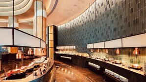 A modern hotel lobby with a curved reception desk, marble flooring, and a high ceiling with circular light fixtures. - Oriental Riverside Hotel Shanghai (Shanghai)