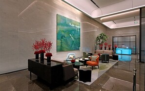 A modern lobby with a large abstract painting, seating area with sofas and chairs, and a reception desk. - Oriental Riverside Hotel Shanghai (Shanghai)