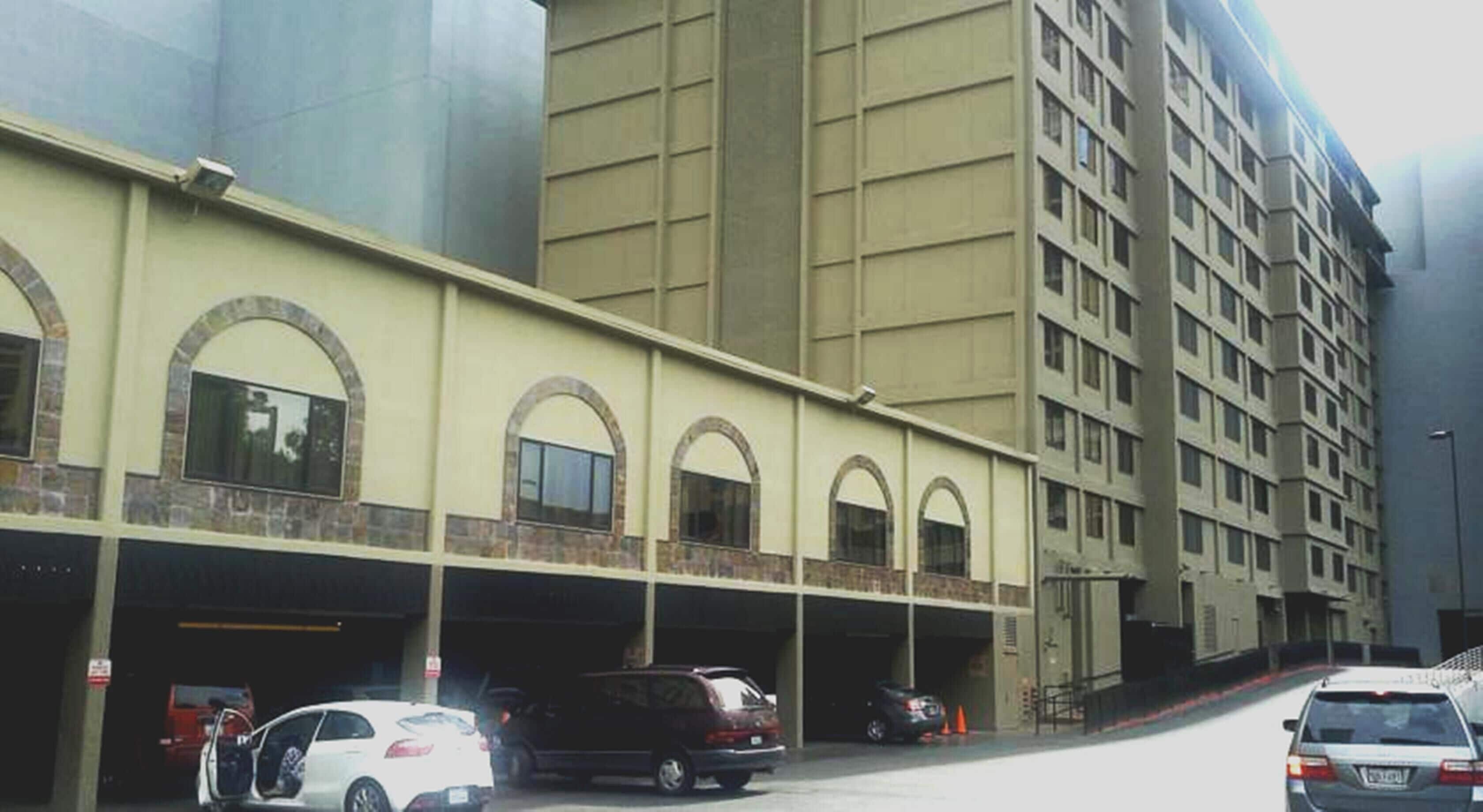 A multi-story building with a parking garage.