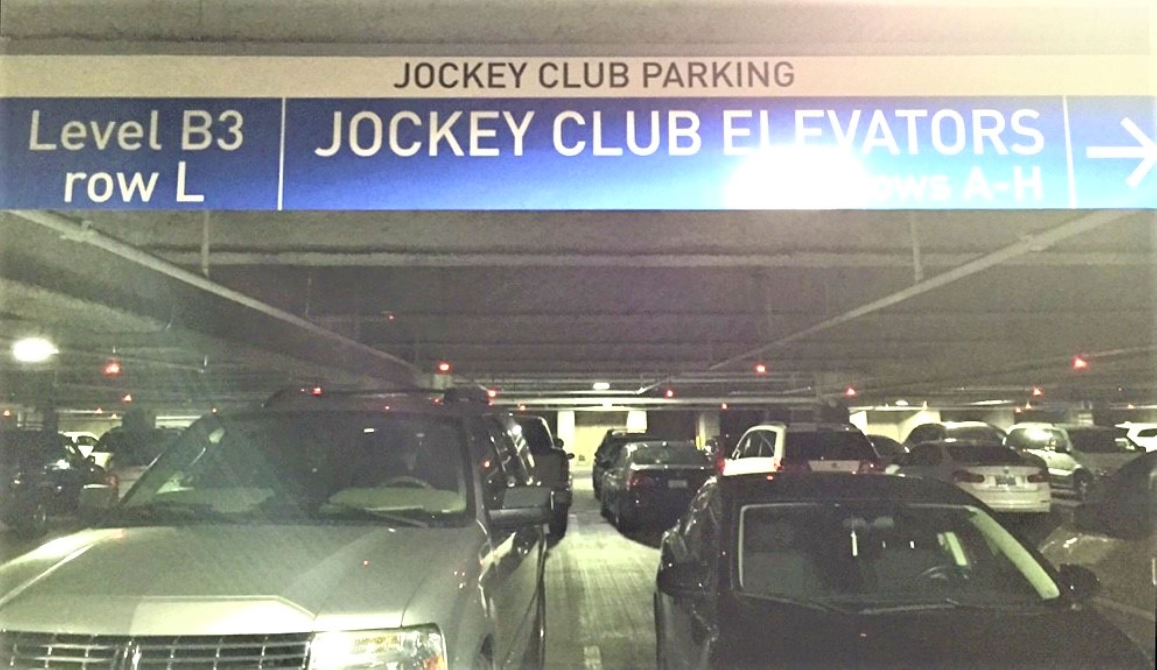 A parking garage with multiple levels and rows, including Level B3 row L and Jockey Club Elevators.