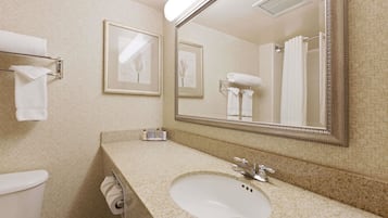A bathroom with a sink, mirror, towel rack, and toilet.