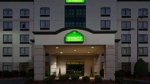 A hotel entrance with a sign reading "Wingate by Wyndham" and the address "4238". - Wingate by Wyndham Charlotte Airport I-85/I-485 (Charlotte)