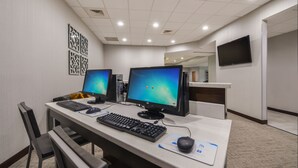A computer lab with two desktop computers, a keyboard, a mouse, and a chair. - Wingate by Wyndham Charlotte Airport I-85/I-485 (Charlotte)
