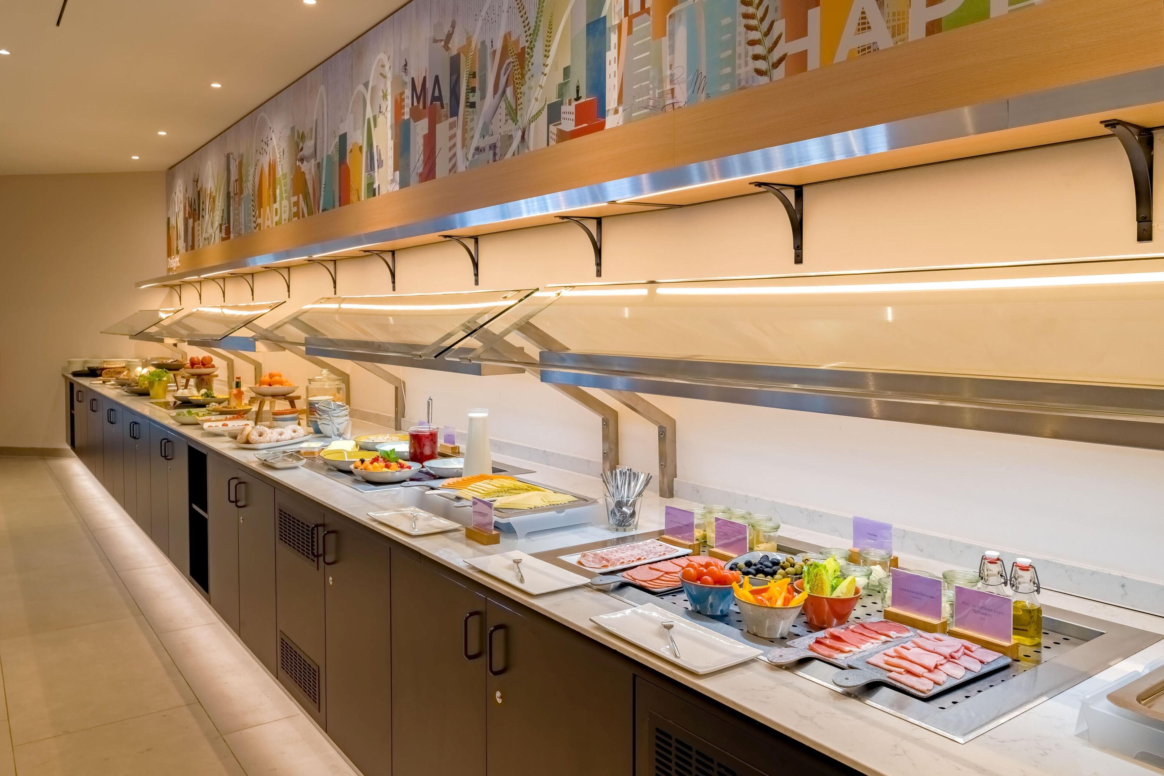 A buffet with various food items and condiments.