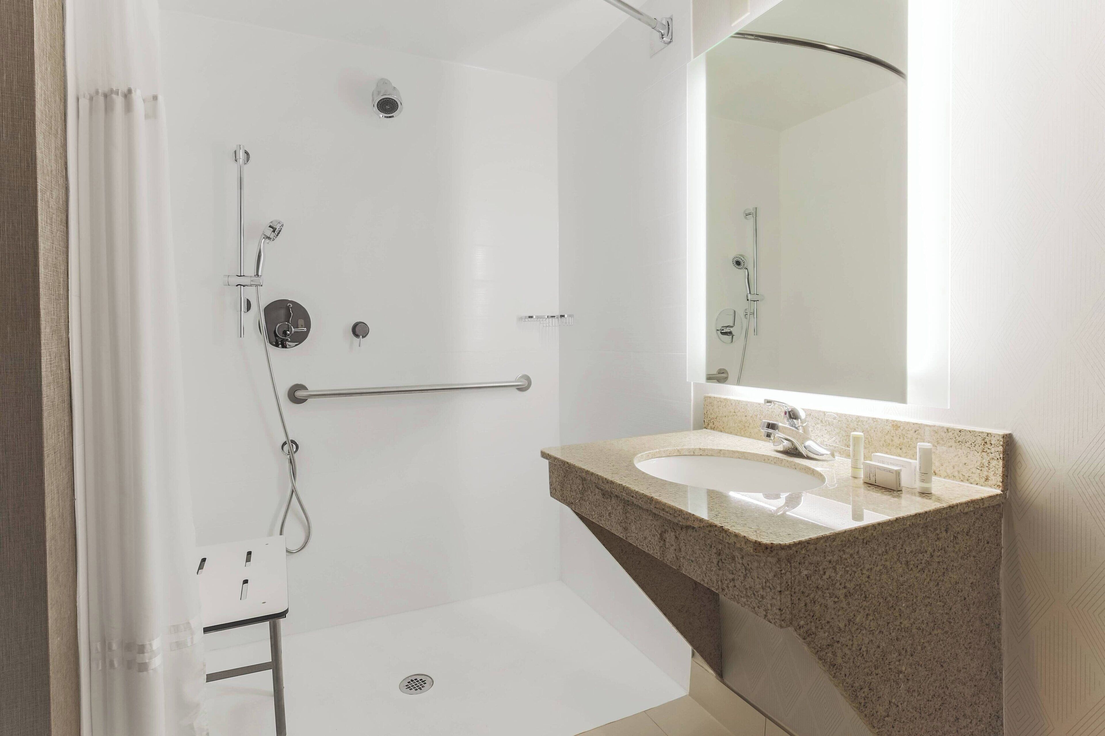 combined shower/bathtub, designer toiletries, hair dryer, towels