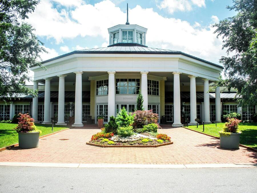A large building with a central entrance, columns, and a tower.