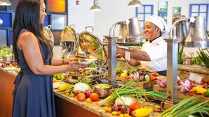 A buffet setup with various food items and a server. - The Jamaica Pegasus Hotel (Kingston)