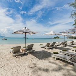 On the beach, white sand, beach umbrellas, beach towels