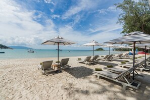 On the beach, white sand, beach umbrellas, beach towels
