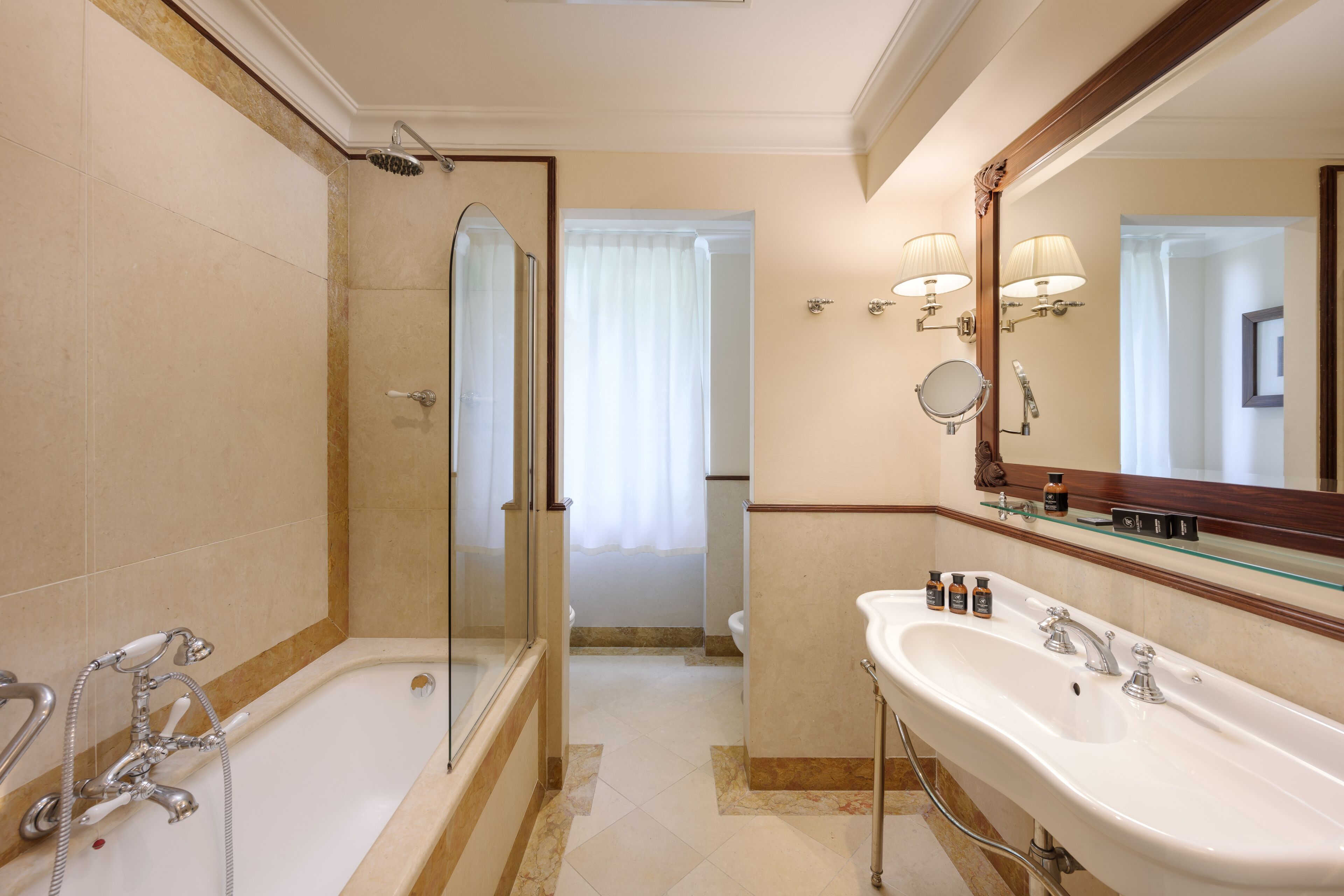 A bathroom with a bathtub, shower, and sink.