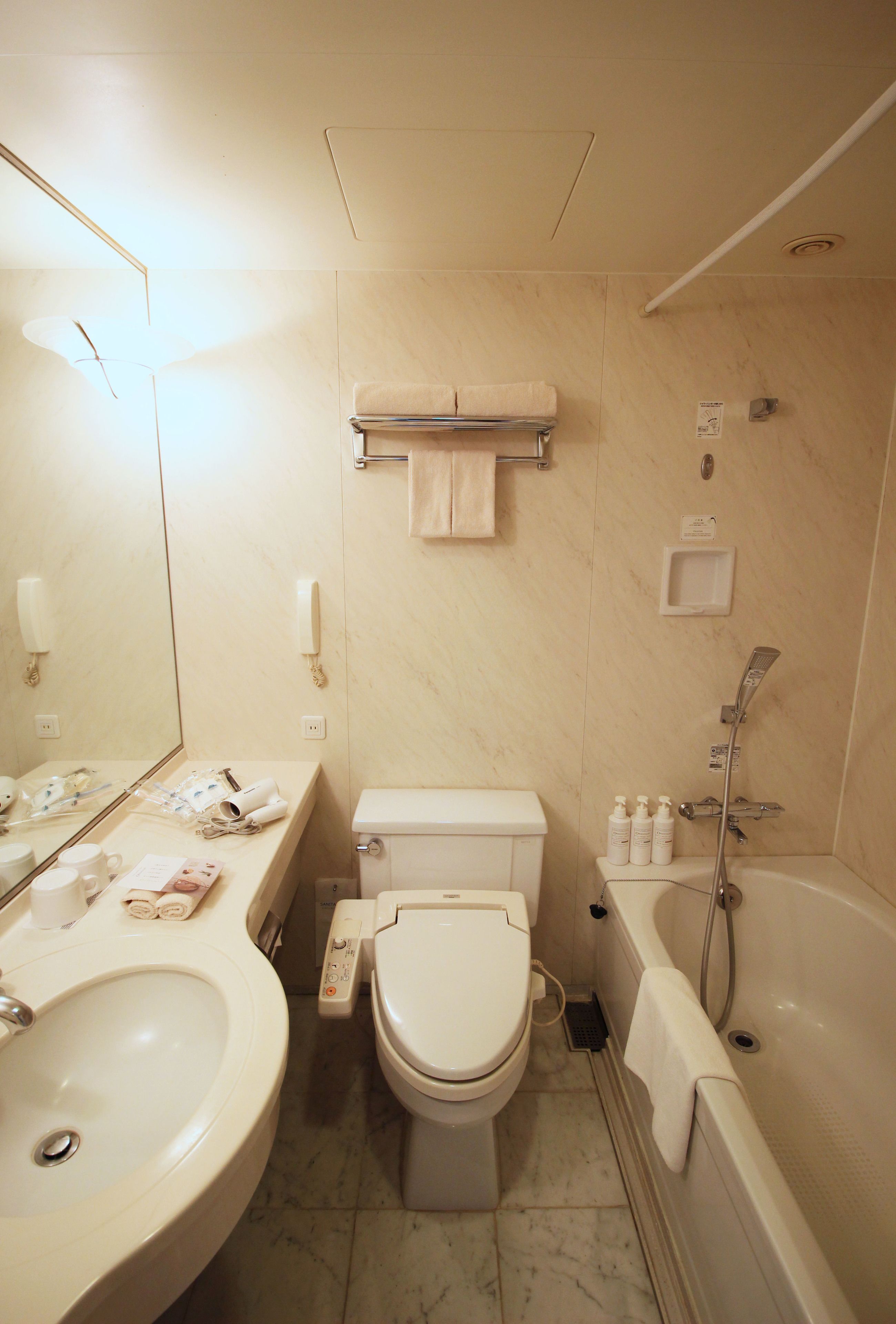 A bathroom with a sink, toilet, and bathtub.