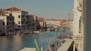 A canal with buildings and a bridge in the background. - Sina Palazzo Sant'Angelo (Venice)