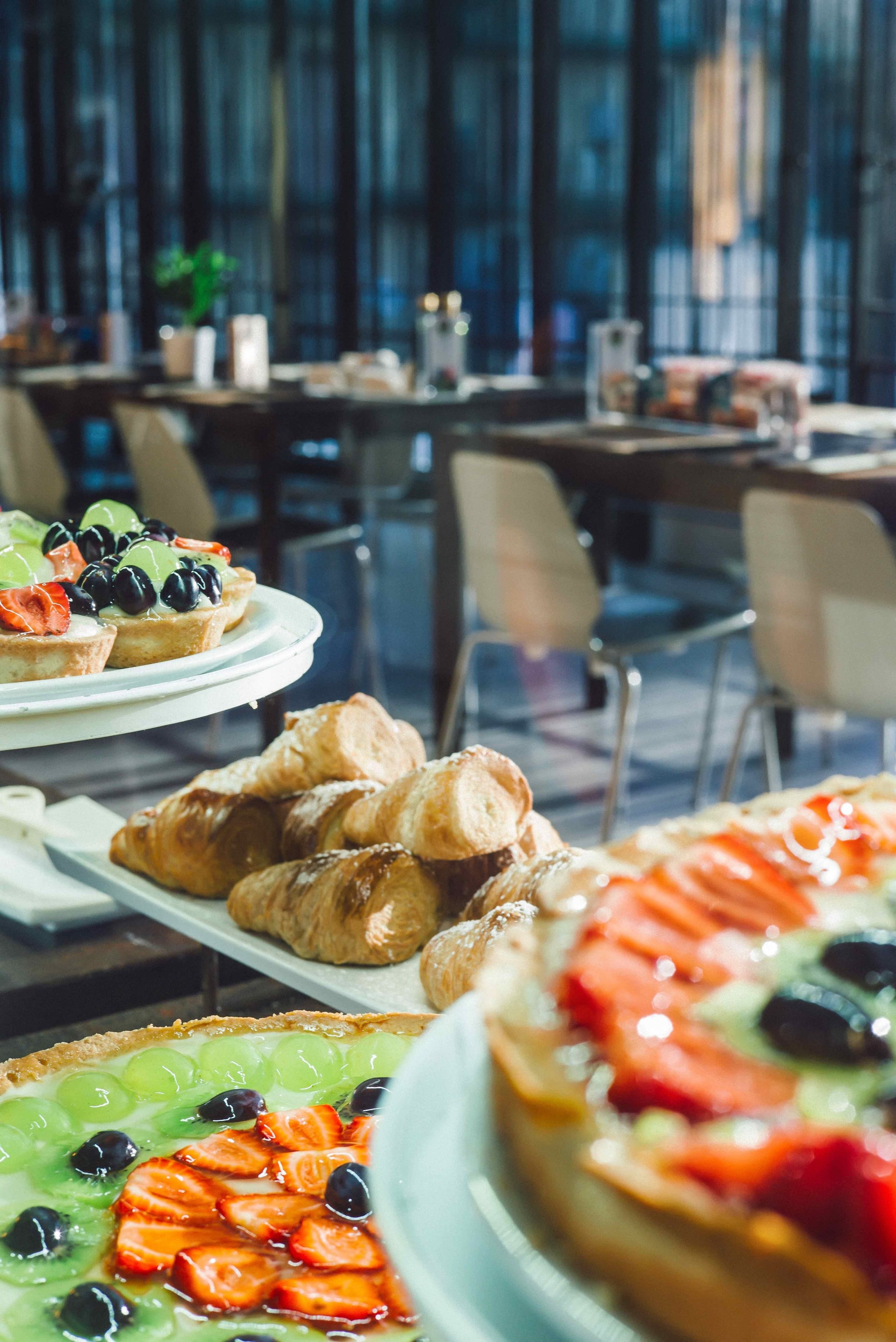 A buffet with various pastries and desserts.