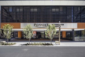 Experience the sleek entrance of Peppers Waymouth Hotel, set amidst lush greenery.