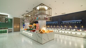 A modern hotel lobby with a marble reception desk, a decorative ceiling structure, and a wall of decorative vases. - Dong Fang Hotel Guangzhou (Guangzhou)