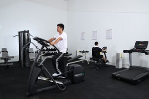 A gym with treadmills, a stationary bike, and weight machines.