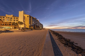 On the beach, white sand, sun-loungers, beach umbrellas
