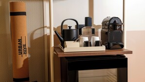 A kitchen area with a coffee machine, a kettle, a scale, and a large brown paper bag labeled 'URBAN.' - Urban Hive Paris (Paris)