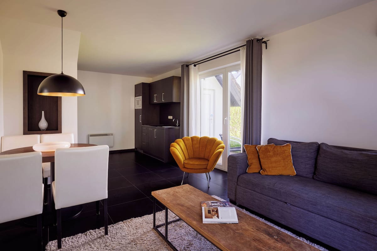 Standard Apartment | Living area | 32-inch flat-screen TV with digital channels, TV, toys
