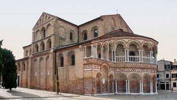 A historic building with arched windows and a balcony.