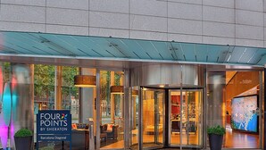 A hotel entrance with a glass door, a sign reading "FOUR POINTS BY SHERATON Barcelona Diagonal", and a potted plant. - Four Points By Sheraton Barcelona Diagonal (Barcelona)