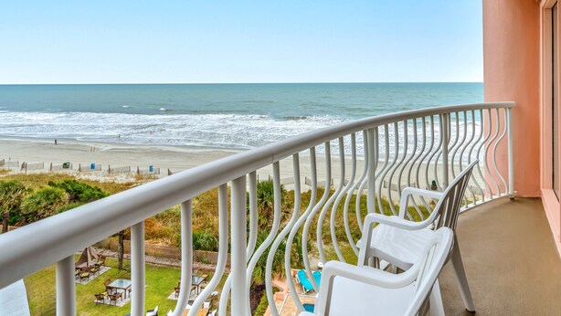 A balcony with a view of the beach and ocean. - The Caravelle Resort (Myrtle Beach)